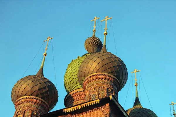 Old beautiful red-brick Russian Orthodox Church with its green d Stock Photo