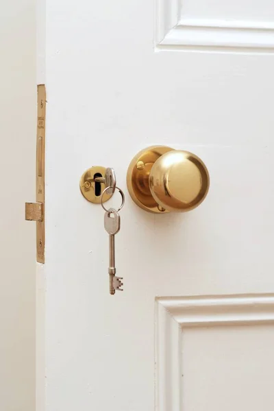 Beyaz kapıda altın anahtarın yakın çekim
