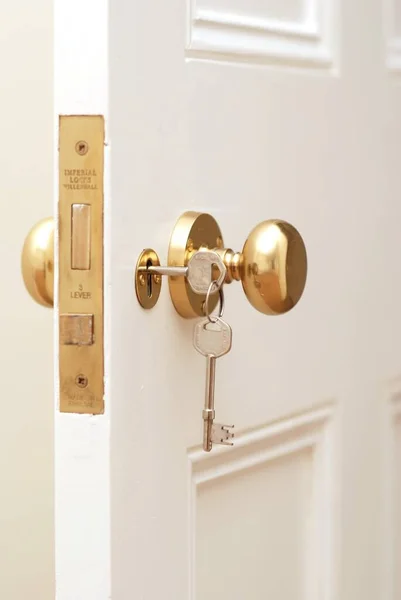 Beyaz kapıda altın anahtarın yakın çekim