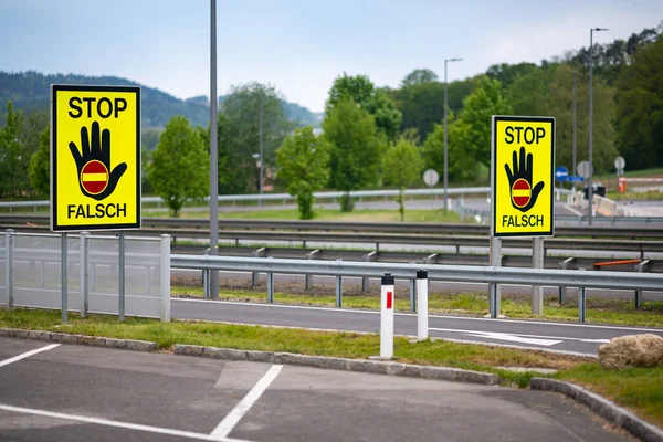 Empty highway in the austrian countryside with the STOP/ FALSCH (stop / false) sign to warn the drivers