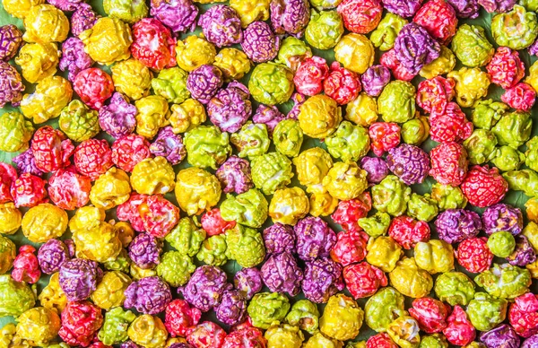 Bright caramel popcorn. Multicolored popcorn. Backgrounds and textures.