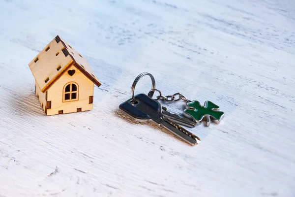 The little house next to it is the keys. Symbol of hiring a house for rent, selling a home, buying a home, a mortgage