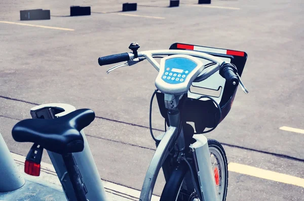 City bike rental system. Bicycle parts are large. Parking bicycles on city streets. With tinting and blurring.