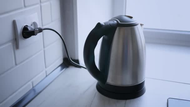 Heating of kettle with water close-up on white wooden table in room. Close up. — Stock Footage Heating Kettle Water Close White Wooden Table Room Close Royalty Free Stock Video