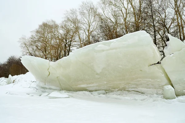 A large block of ice on the shore.