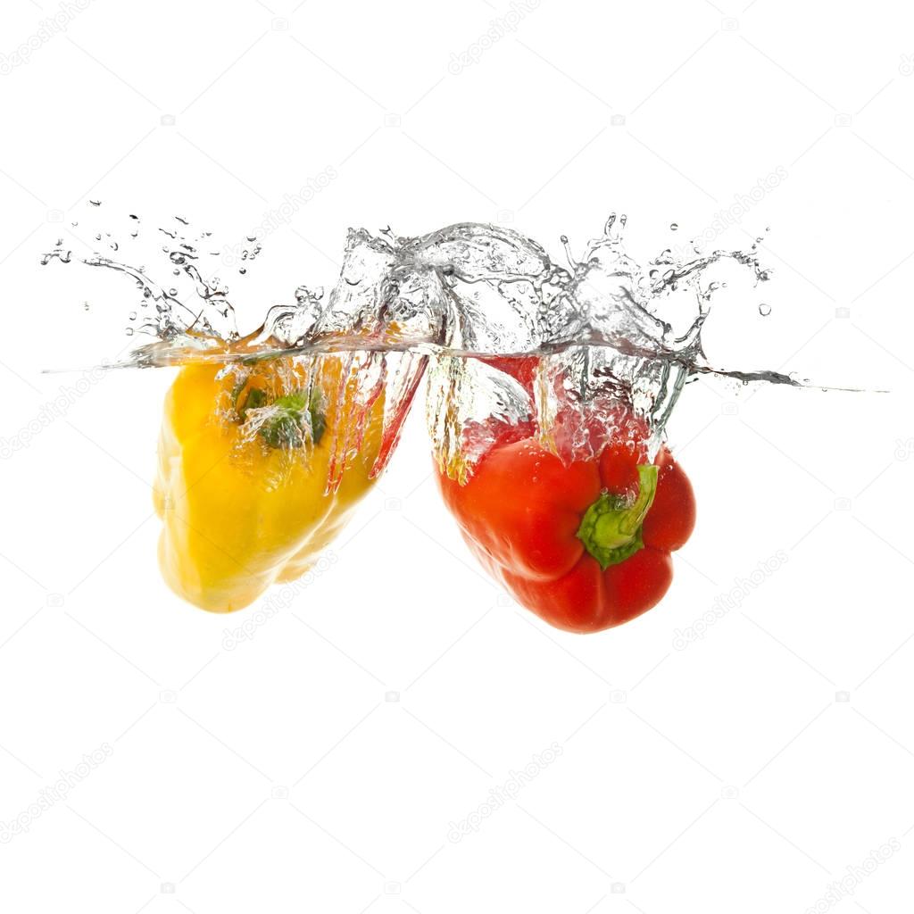 yellow and red pepper vegetables making splash in water