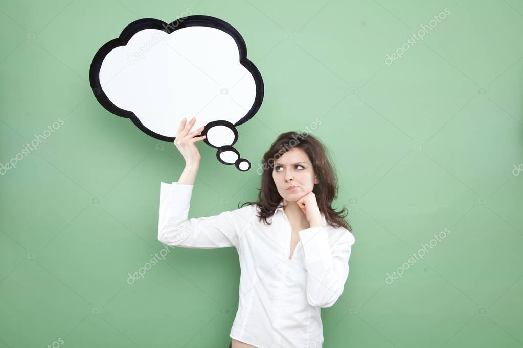 pretty young brunette caucasian woman thinking ideas with comic baloon  on green background