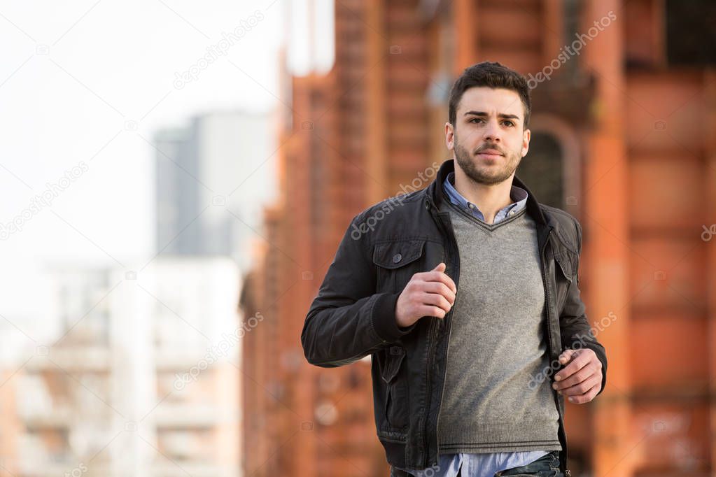 casual caucasian man running in urban city