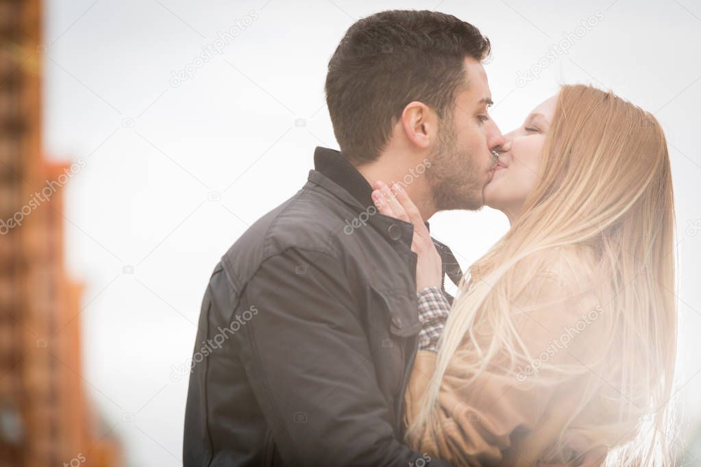 woman romantic love kiss man in urban city