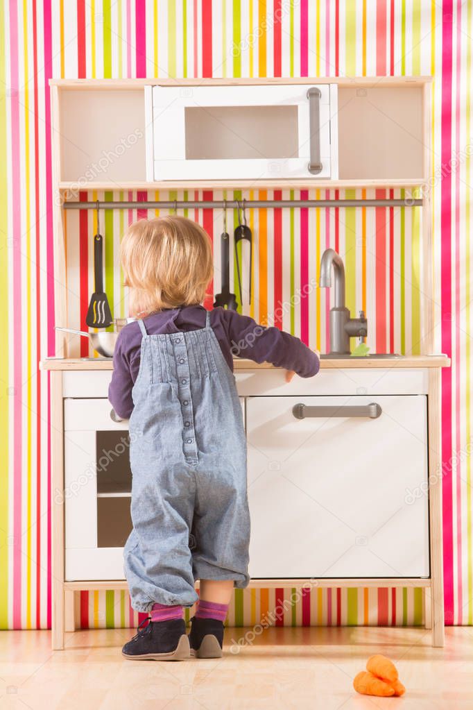 baby family girl daughter play cooking in toy kitchen