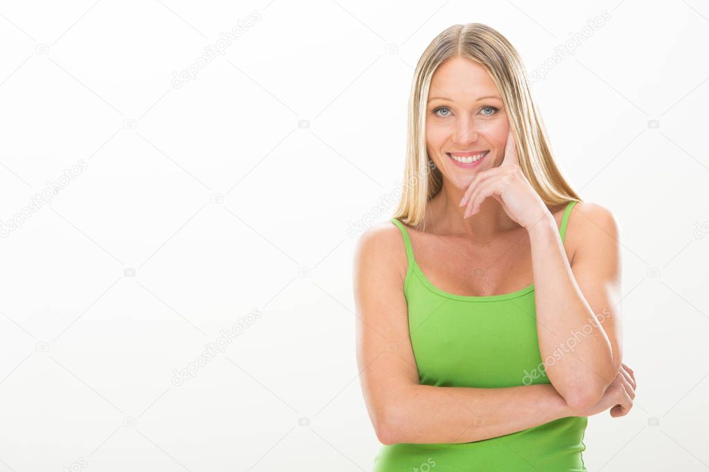 blonde smiling young woman with green dress isolated on white