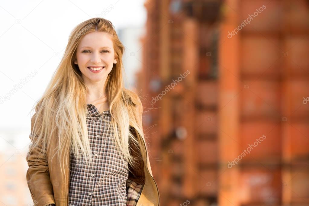 smiling happy young caucasian blond woman urban