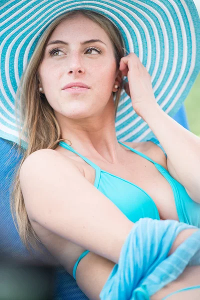 Mooie jonge Kaukasische blonde vrouw in blauwe bikini portret op zwembad — Stockfoto