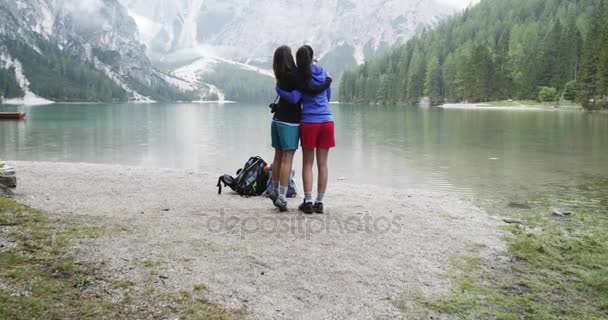 Duas mulheres abraçam e conversam no lago Braies — Vídeo de Stock