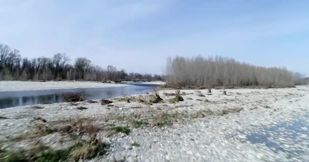 Moving forward over river bed in autumn or winter. Outdoor sunny nature scape riverbed near forest wild aerial establisher.4k drone flight establishing shot — Stock Video