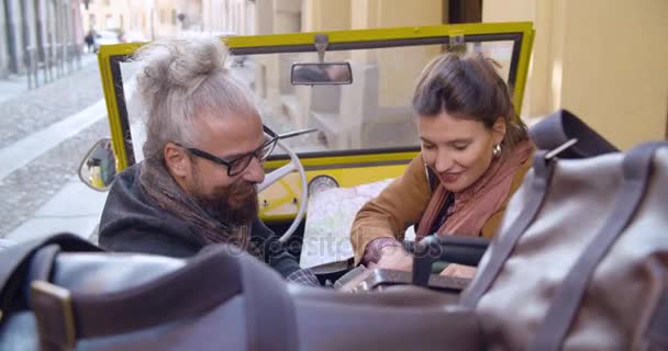 Mann und Frau suchen im Rücksitz Gepäck oder Koffer mit angehaltenem Fahrzeug entlang der Straße. Kaukasische echte Paar verliebt Roadtrip Urlaub Italienisch Reise auf Cabrio-Oldtimer. 4k Handheld-Video — Stockvideo