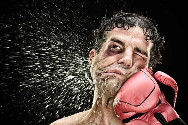 Silly boxer man takes a punch in the face isolated on black.funny concept portrait — Stock Photo, Image