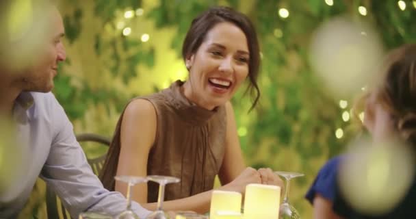 Four people, two couples happy talking and eating during a romantic gourmet dinner or lunch.Shiny lighting.Medium shot. Friends italian trip in Umbria.4k slow motion — Stock Video