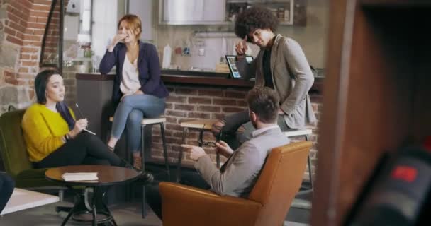 Collega 's en klanten praten strategie in eethoek.Groep van multi-etnische mensen die informele zakelijke team vergadering in restaurant lounge.Teamwork, corporate, diversiteit en sociale concepten — Stockvideo