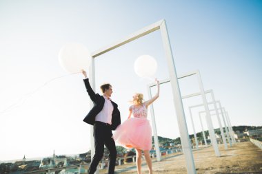 Sevgi dolu çift atlama ve eski şehir'in backgrounf ile çatı üzerinde gülümseyen