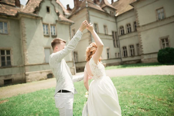 Bella coppia di sposi romantici che si abbracciano vicino al vecchio castello — Foto Stock