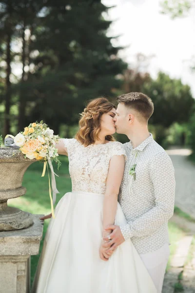 Newly married couple running and jumping in park while holding hands — Stock Photo, Image