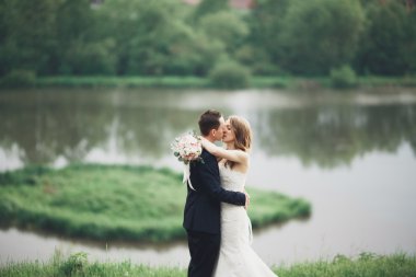 Romantik düğün çift karı güzel göl kenarında poz,