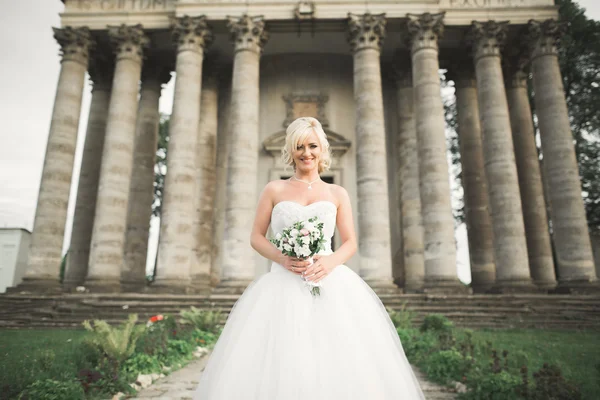 完璧なウェディング ドレスとブーケの古いお城に近いポーズ美しいエレガントな花嫁 — ストック写真