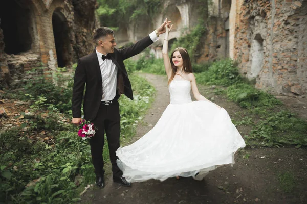 Happy newlyweds near the ancient castle on the walk — Stock Photo, Image