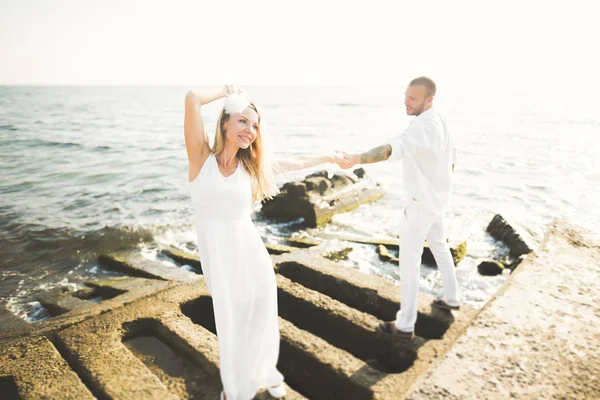 Happy romantic fashion couple in love have fun on beautiful sea at summer day