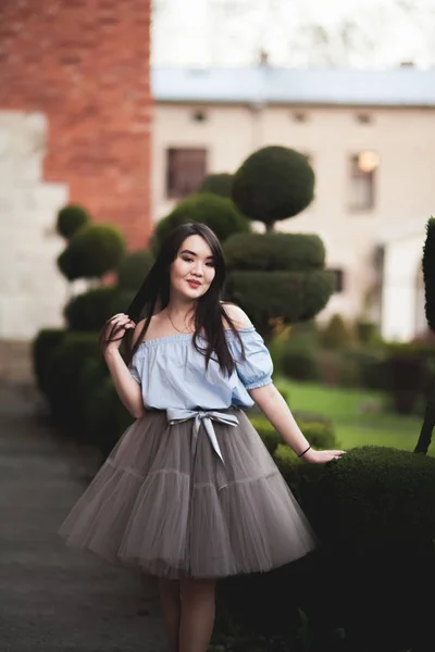 Junge asiatische Mädchen mit modernem Kleid posieren in einem alten Krakow — Stockfoto