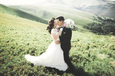 Güzel düğün çift, gelin ve damat, arka planda dağların aşık