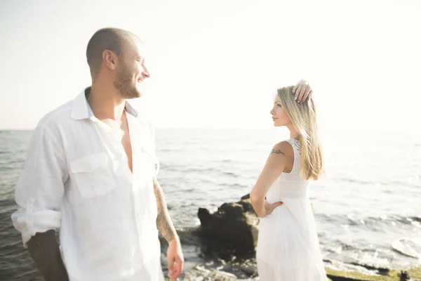 Happy romantic fashion couple in love have fun on beautiful sea at summer day