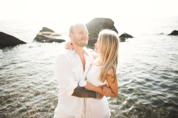 Felice appena sposato giovane coppia di nozze che celebra e divertirsi al tramonto bella spiaggia — Foto Stock