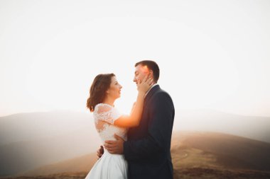 Düğün çifti düğün gün batımında poz. Gelin ve damat aşık