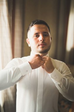 Damat sabah hazırlığı. Yakışıklı adam giyiniyor ve düğüne hazırlanıyor.