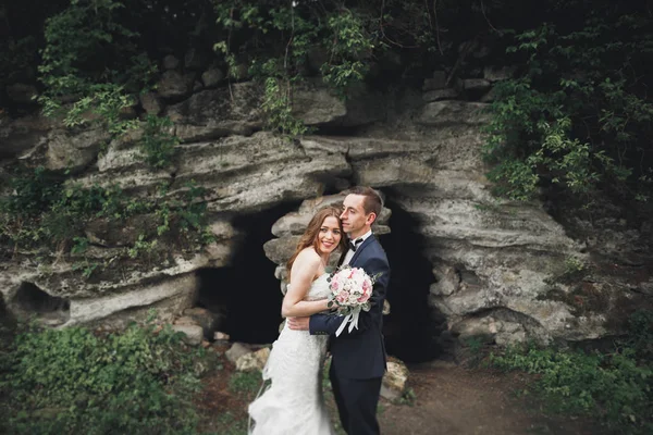 Allegro matrimonio coppia posa nea rocce — Foto Stock