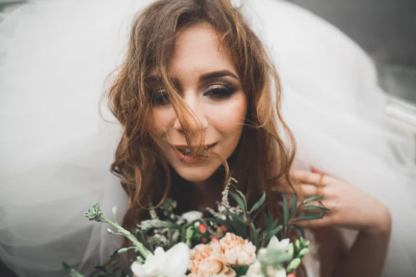 Portrait of a beautiful happy bride with bouquet — Stok Foto