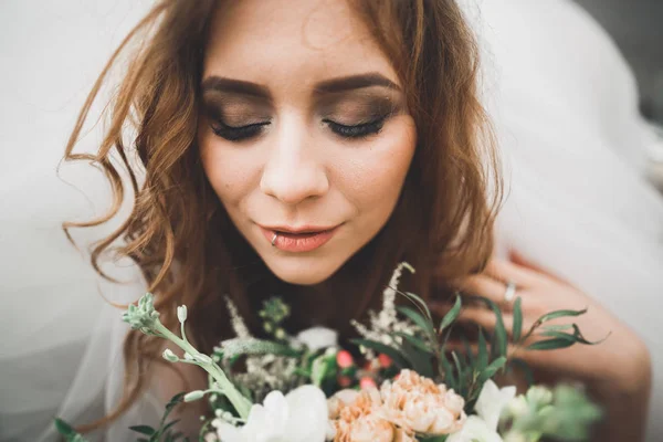 Portrait of a beautiful happy bride with bouquet — Stok Foto