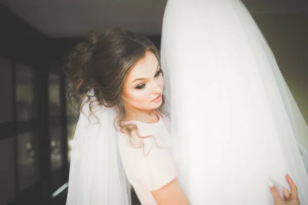 Noiva de luxo em vestido branco posando enquanto se prepara para a cerimônia de casamento — Fotografia de Stock