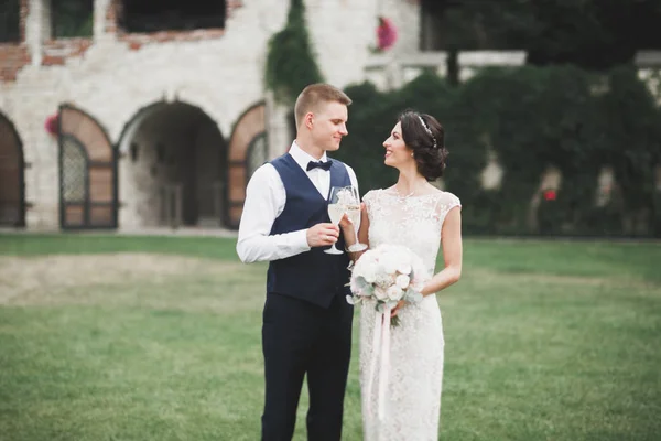 Casal feliz encantador do casamento, noiva com vestido branco longo posando na cidade bonita — Fotografia de Stock