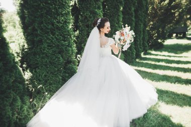 Gelinlik içinde dışarıda poz veren güzel gelin.