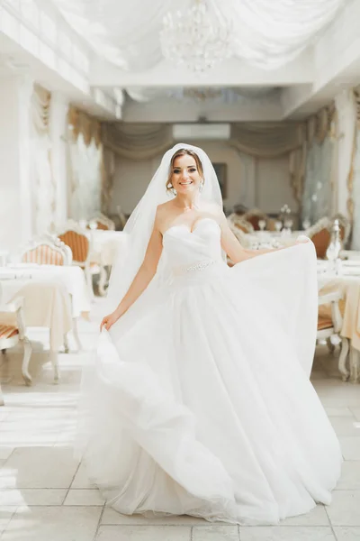 Mooie bruid poseren in trouwjurk in fashion hotel — Stockfoto