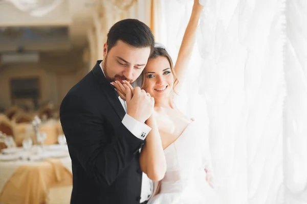 Séance photo de mariage du couple de jeunes mariés posant dans un bel hôtel — Photo