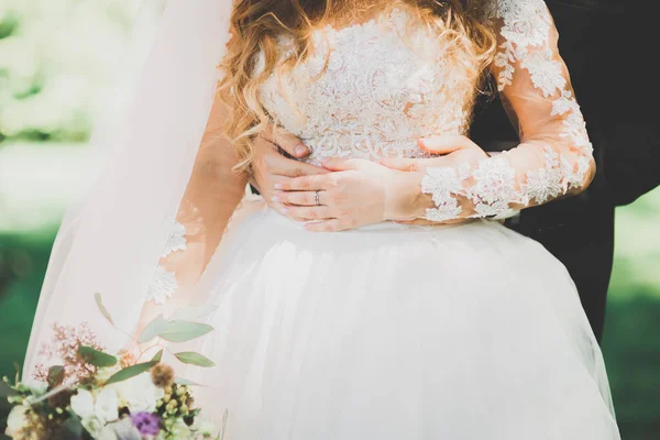 Bride holding big and beautiful wedding bouquet with flowers — Stock Photo, Image