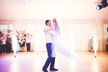 Güzel beyaz bir çift yeni evlendiler ve ilk danslarını ediyorlar.