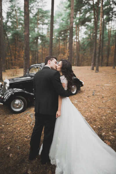 Pareja recién casada en el lujoso coche retro el día de su boda — Foto de Stock