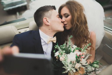 Mutlu gelin ve damat selfie düğünlerinde retro arabaya yapma.