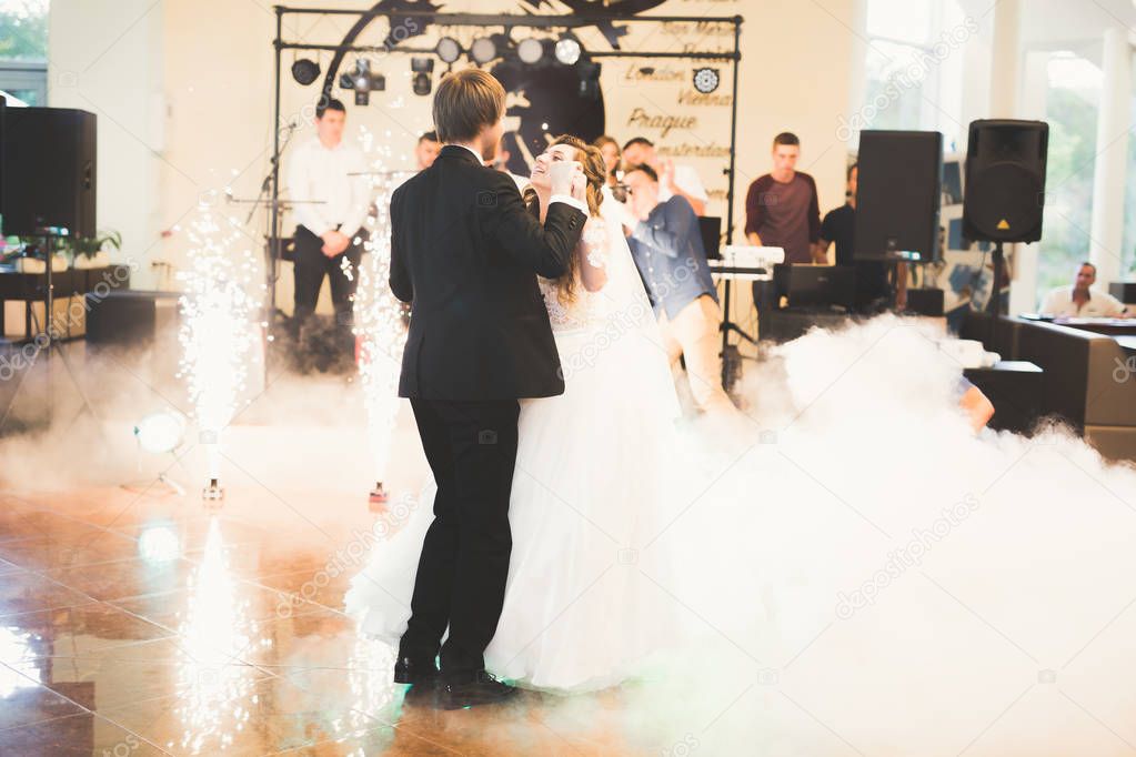 Beautiful caucasian wedding couple just married and dancing their first dance