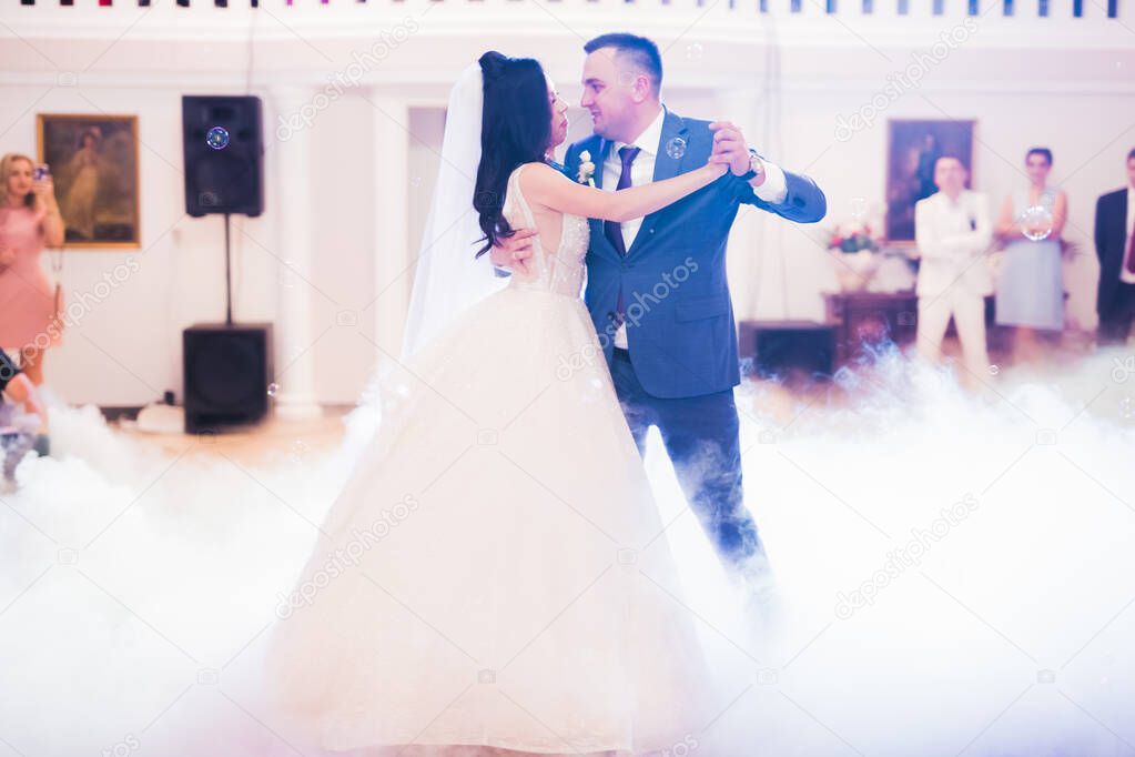 Beautiful wedding couple just married and dancing their first dance